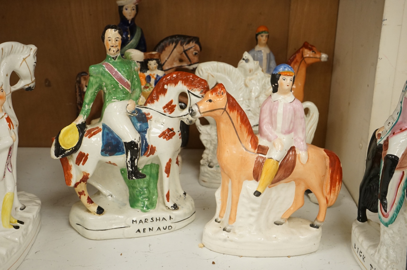 Thirteen Staffordshire pottery equestrian figures to include Tom King, Dick Turpin and Sir Colin Campbell, largest 28cm high